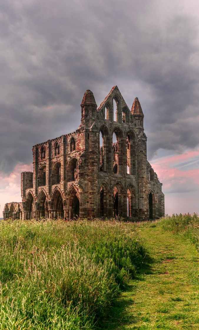 photo of old church building under cloudy sky